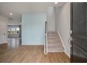 Inviting entryway with hardwood floors, staircase, and a serene blue accent wall at 208 Evergreen Ave, Summerville, SC 29485