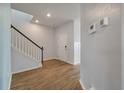 Hallway featuring hardwood floors, staircase with modern railing, and neutral paint at 208 Evergreen Ave, Summerville, SC 29485