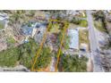 Aerial view of the property, showcasing its boundaries, nearby street, and surrounding trees at 209 E 1St N St, Summerville, SC 29483