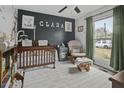 Cozy Bedroom featuring a wooden crib, glider chair, and cheerful decor at 214 Terry Ave, Summerville, SC 29485
