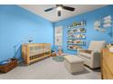 Cozy Bedroom with a crib, rocking chair, playful decor, and soft lighting at 219 Symphony Ave, Summerville, SC 29486