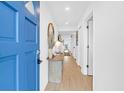 Bright entryway with wood look floors and a blue door at 2395 Folly Road # 4H, Folly Beach, SC 29439