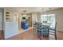 Open dining area with wood floors, a modern chandelier, and sliding glass doors at 242 Two Pond Loop, Ladson, SC 29456