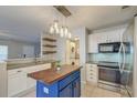 Stylish kitchen with a blue island, stainless steel appliances, and modern lighting at 242 Two Pond Loop, Ladson, SC 29456