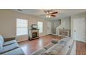 Inviting living room with a cozy fireplace, wood floors, and natural light at 242 Two Pond Loop, Ladson, SC 29456