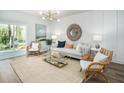 Cozy living room featuring stylish furniture, a large rug, and sliding glass doors leading to the outdoor space at 307 Tiliwa St, Summerville, SC 29486