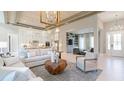 Spacious living room with light walls, open to the kitchen, modern decor, and wood-look floors at 4 Preserve Rd, Johns Island, SC 29455