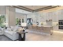 Open-concept kitchen and living area featuring a large island with seating and modern decor at 4 Preserve Rd, Johns Island, SC 29455