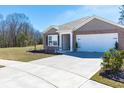 Beautiful single-story home boasting a well-maintained lawn and a spacious two-car garage at 409 Spruce Ivy St, Moncks Corner, SC 29461