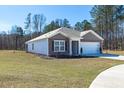 Well-maintained single-story home with attached two-car garage and green front lawn at 409 Spruce Ivy St, Moncks Corner, SC 29461