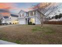 Charming two-story home with gray siding and a spacious front yard, offering a welcoming and picturesque setting at 416 Forest Hills Rd, Summerville, SC 29486