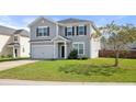 Attractive two-story home with gray siding and an attached garage, surrounded by a green lawn at 416 Forest Hills Rd, Summerville, SC 29486
