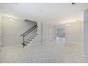 Open living room featuring tile floors, staircase, chandelier, and lots of natural light at 416 Forest Hills Rd, Summerville, SC 29486