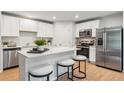 Modern kitchen with white cabinets, stainless steel appliances, and an island with bar stool seating at 4175 Rising Tide Dr, Summerville, SC 29485