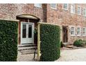 Exterior brick home features a courtyard and lush green landscaping at 42 1/2 Hasell St, Charleston, SC 29401
