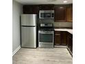 Modern kitchen with stainless steel appliances, dark cabinets, and plenty of counter space at 4230 S Rhett Ave, North Charleston, SC 29405