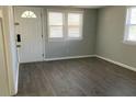 A cozy living room featuring sleek laminate flooring and an abundance of natural light at 4230 S Rhett Ave, North Charleston, SC 29405