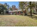 Inviting brick home with manicured lawn and picturesque landscaping at 425 Ravenwood Rd, Walterboro, SC 29488