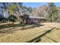 Quaint brick home surrounded by lush greenery and a peaceful setting at 425 Ravenwood Rd, Walterboro, SC 29488
