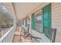 Cozy front porch features rocking chairs, green shutters, and a welcoming atmosphere at 634 Lakeside Dr, Moncks Corner, SC 29461