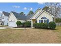 Lovely one story home with manicured shrubs, a well-maintained lawn, and an attached garage at 8153 Governors Walk, North Charleston, SC 29418
