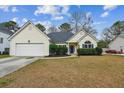 Inviting single Gathering home with blue shutters, mature landscaping, and a two car garage at 8153 Governors Walk, North Charleston, SC 29418