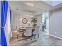 Elegant dining room featuring a modern chandelier, round table with chairs, and blue curtains at 100 Hunters Wood Dr, Summerville, SC 29485
