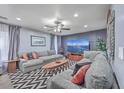 Comfortable living room with gray sofas, a ceiling fan, a large screen television, and stylish decor at 100 Hunters Wood Dr, Summerville, SC 29485