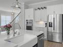 Bright kitchen with white cabinets, stainless steel appliances, a white farmhouse sink, and a breakfast bar at 1020 Lyle Way, Mount Pleasant, SC 29466