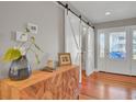 Beautiful foyer with hardwood floors, barn door, and natural light creating a welcoming atmosphere at 1048 Wharf Indigo Pl, Mount Pleasant, SC 29464
