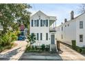 Inviting two-story home with a cozy second-story porch and gated driveway at 107 Bogard St, Charleston, SC 29403