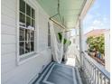 Relaxing porch with white railings, a stylish rug, and a comfortable hammock at 107 Bogard St, Charleston, SC 29403
