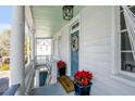 Welcoming porch featuring elegant columns, a wreath, and potted poinsettias at 107 Bogard St, Charleston, SC 29403
