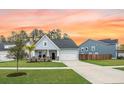 Inviting single-story home with a well-maintained lawn, driveway, and cozy front porch at 114 Belfort Pl, Summerville, SC 29486