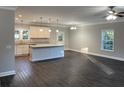 Open-concept living space featuring modern lighting, hardwood floors, and a kitchen with a center island at 149 Rose Ave, Walterboro, SC 29488