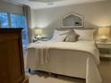 Relaxing bedroom features soft lighting, a decorative mirror, and a comfortable bed with plush pillows at 1545 Ashley River Rd # 3K, Charleston, SC 29407