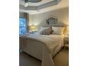 Relaxing bedroom features soft lighting, a decorative mirror, and a comfortable bed with plush pillows at 1545 Ashley River Rd # 3K, Charleston, SC 29407