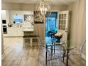 Bright dining area features a glass table and a view of a sunny outdoor patio at 1545 Ashley River Rd # 3K, Charleston, SC 29407