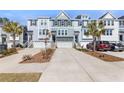 Attractive townhomes with attached garages, driveways and green space at 1549 Moss Spring Rd, Mount Pleasant, SC 29466