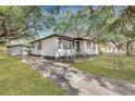Charming home with a long driveway, fenced yard, and storage shed in backyard at 1652 Larry St, North Charleston, SC 29405