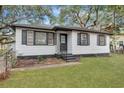This inviting home features a freshly painted exterior, classic shutters, and cozy porch at 1652 Larry St, North Charleston, SC 29405