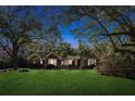 Charming brick home with beautiful landscaping at twilight at 17 Guerard Rd, Charleston, SC 29407