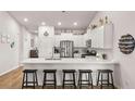Modern kitchen with white cabinets, a spacious island, stainless steel appliances and decorative nautical décor at 187 Granton Edge Ln, Summerville, SC 29486