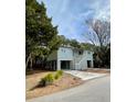 Quaint stilt home with a light-filled, neutral exterior at 2 Sandcrab Ct, Isle of Palms, SC 29451