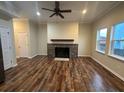 Inviting living room with beautiful flooring, fireplace, and windows letting in natural light at 2100 Booker St, Charleston, SC 29405