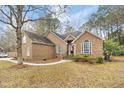 Landscaped brick home featuring arched windows, complimented by an American flag at 298 Hook Ln, Mount Pleasant, SC 29464