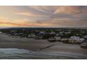 Expansive aerial shot of a coastal neighborhood highlighting beachfront homes and ocean access at 3001 Marshall Blvd, Sullivans Island, SC 29482
