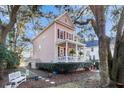 Side view of a beautiful two story home, front porch and landscaped yard with a bench at 3271 Johnstowne St, Johns Island, SC 29455
