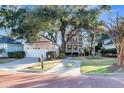 Inviting home featuring a matching detached garage and well-manicured lawn and brick-paved street at 3271 Johnstowne St, Johns Island, SC 29455