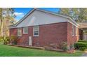 Exterior side view of brick home showing brick detail and small brick-lined garden at 409 Dowling Ave, Walterboro, SC 29488